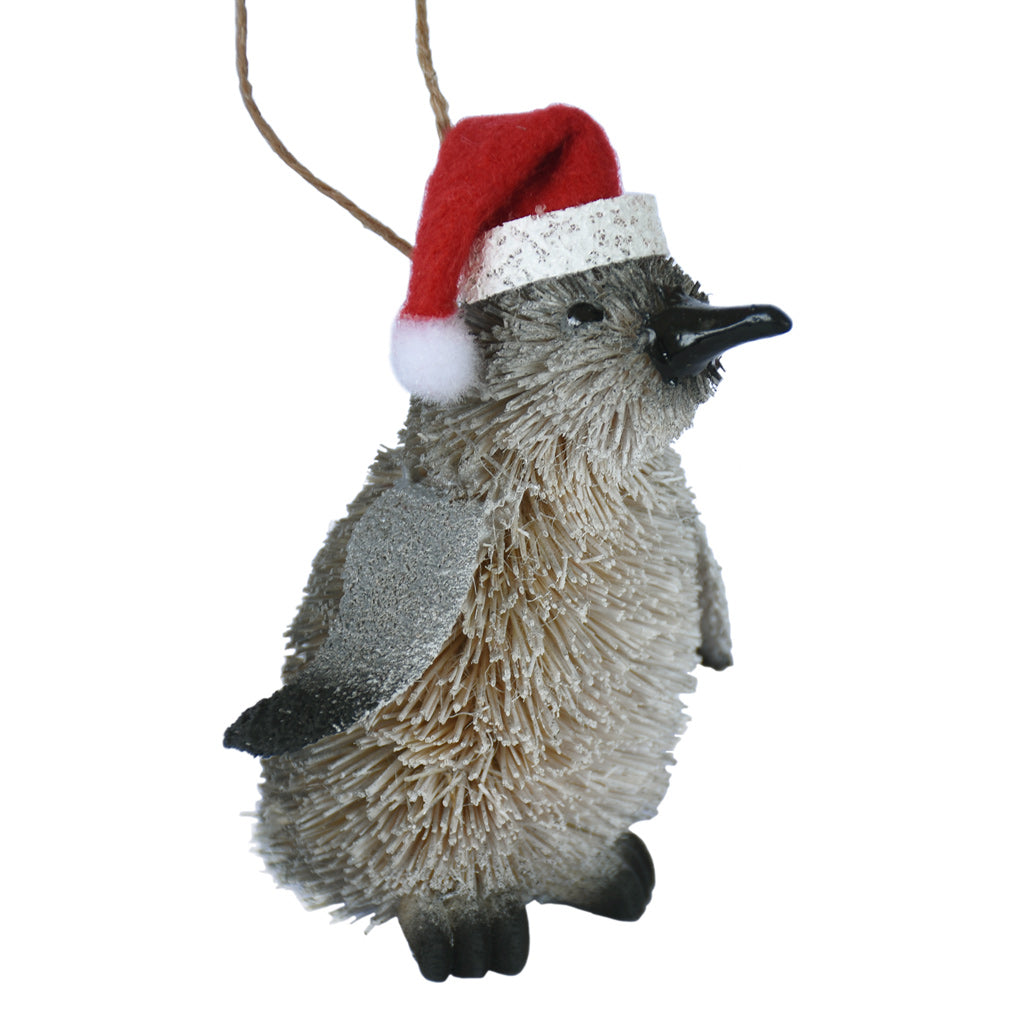 Buri fibre Penguin ornament wearing a Santa hat on a white background